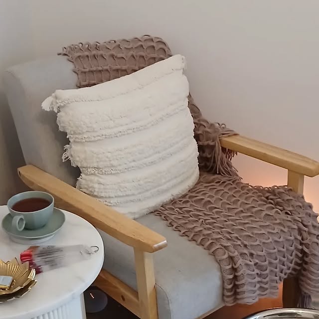 The armchair in the Rejuvenate studio with a cup of tea on the side table